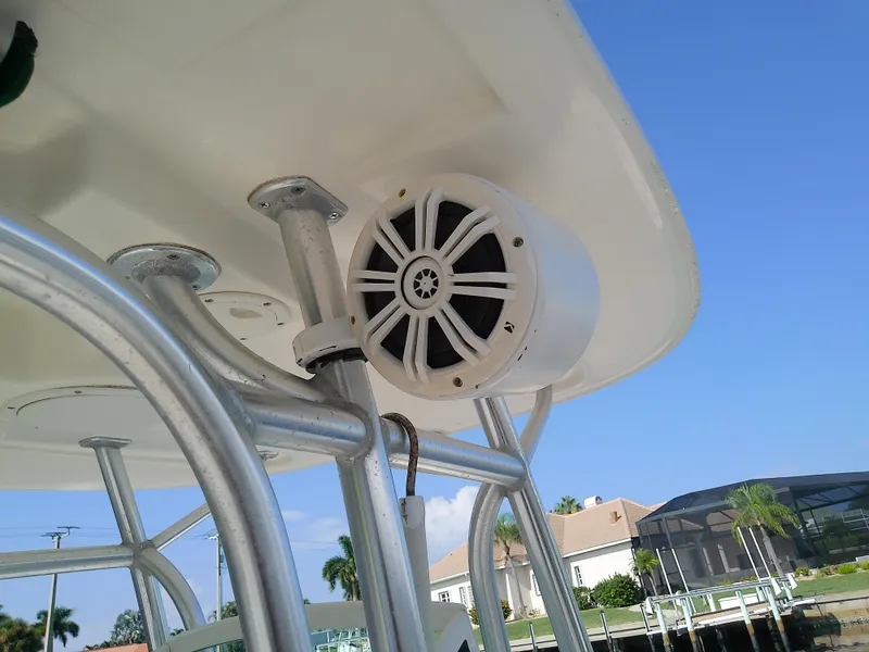 Slide: The Image of 2004 Trophy 2503 Center Console boat with mounted speaker and metal framework. - 49