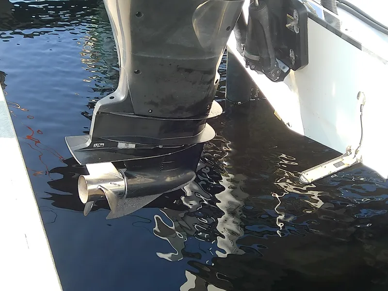 Slide: The Image of Close-up of a 2004 Trophy 2503 Center Console boat motor in water. - 8