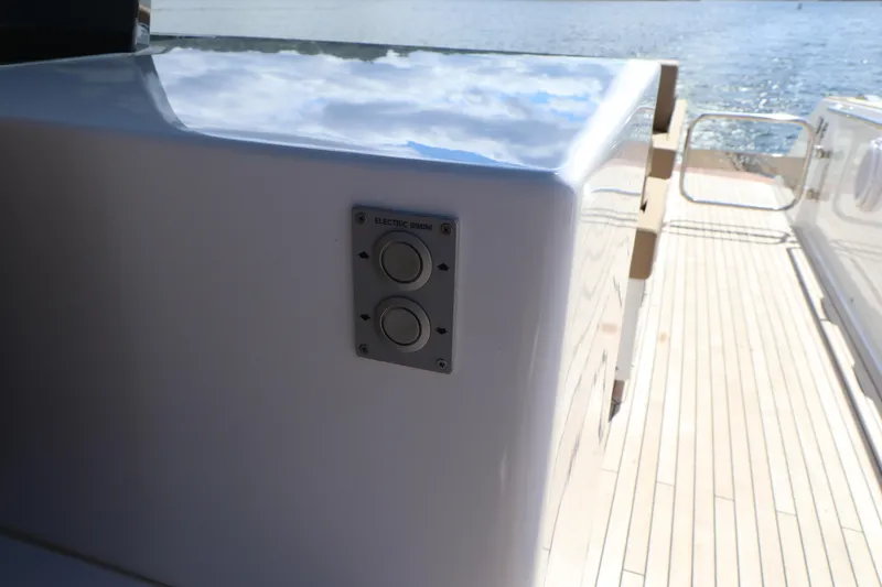 Slide: The Image of Pardo Yachts P43 2024 model, sleek deck design with control panel, overlooking serene waters. - 26