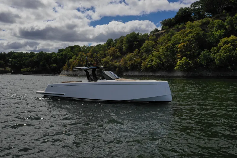 Slide: The Image of 2024 Pardo Yachts P43 cruising on a scenic lake with lush green shoreline. - 6