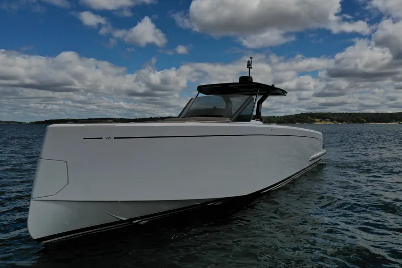Slide: The Image of 2024 Pardo Yachts P43 cruising on a serene lake under a cloudy sky. - 7