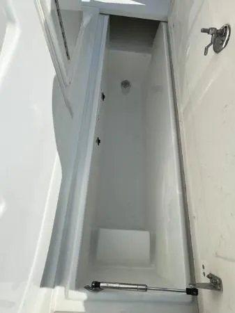 Slide: The Image of 2014 SouthWind 2200 SD boat storage compartment, open and empty. - 16