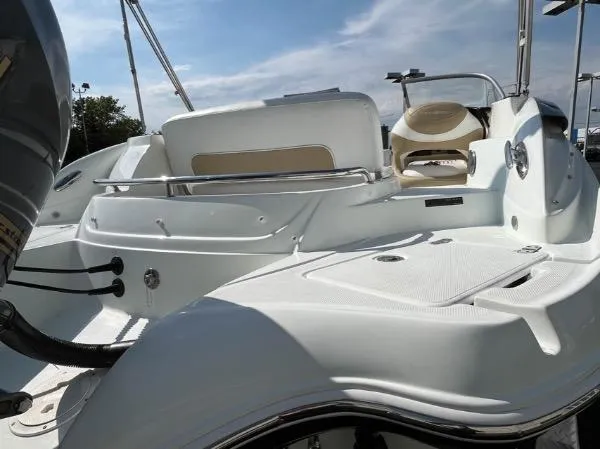 Slide: The Image of 2014 SouthWind 2200 SD boat interior with seating and controls under a clear sky. - 9