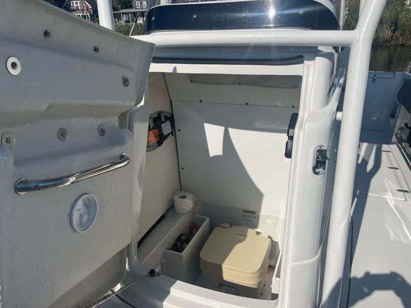 Slide: The Image of 2023 Crownline 220 CC Finseeker boat storage compartment with organized interior. - 13