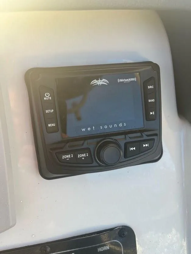 Slide: The Image of Wet Sounds audio system on 2023 Crownline 220 CC Finseeker boat dashboard. - 8