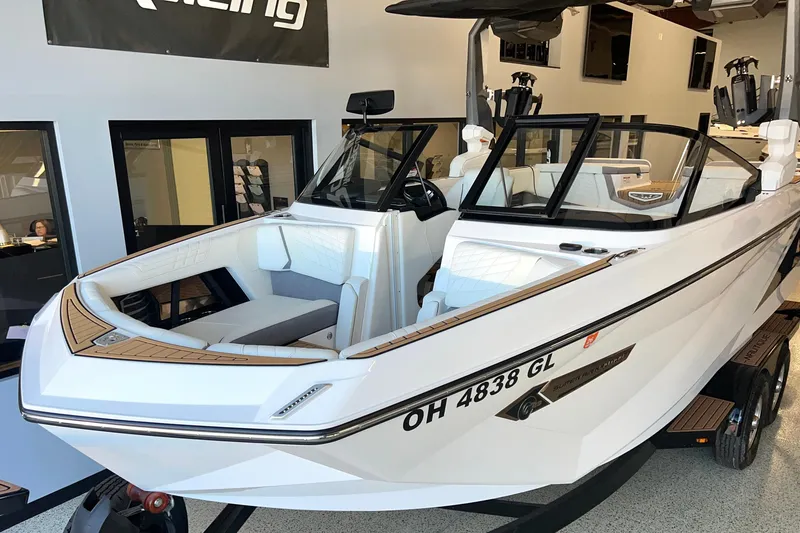 Slide: The Image of 2023 Nautique Super Air G23 boat in showroom, white exterior, sleek design. - 0