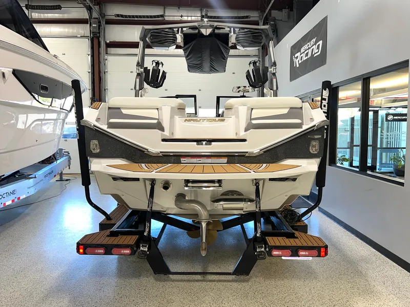 Slide: The Image of 2023 Nautique Super Air G23 boat in showroom, rear view. - 10