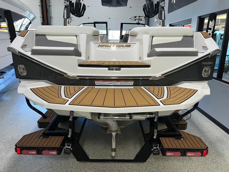 Slide: The Image of 2023 Nautique Super Air G23 boat rear view in showroom. - 11