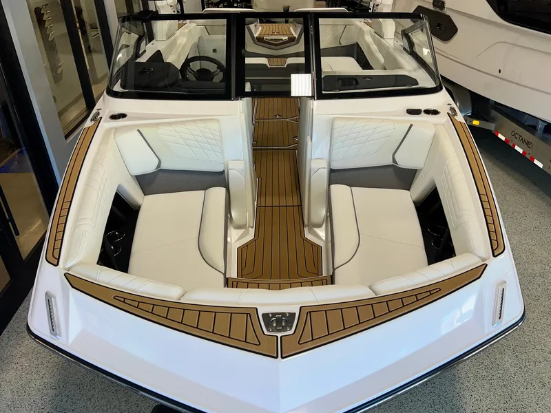 Slide: The Image of 2023 Nautique Super Air G23 boat interior with white seating and wood accents. - 14