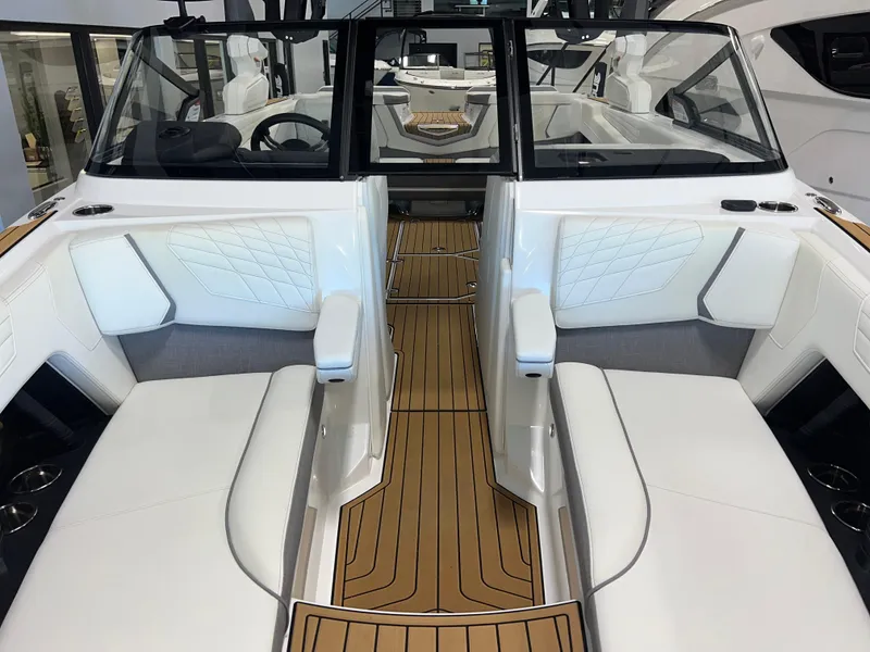 Slide: The Image of 2023 Nautique Super Air G23 interior with white seating and teak flooring. - 15