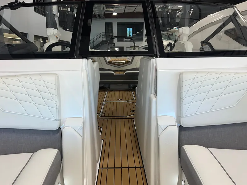 Slide: The Image of 2023 Nautique Super Air G23 interior with white seating and teak flooring. - 16