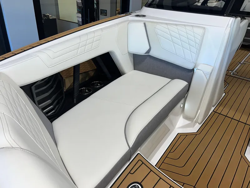Slide: The Image of 2023 Nautique Super Air G23 interior with white leather seating and teak flooring. - 17