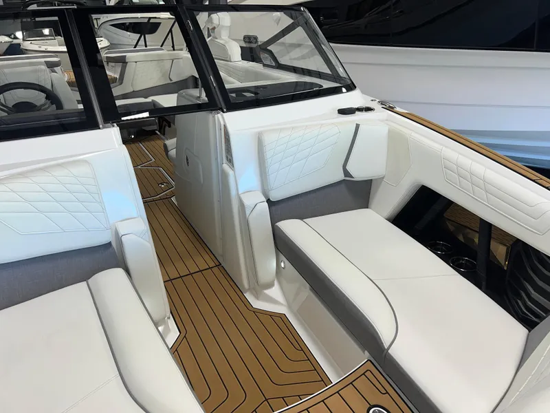 Slide: The Image of 2023 Nautique Super Air G23 interior with white seating and teak flooring. - 18