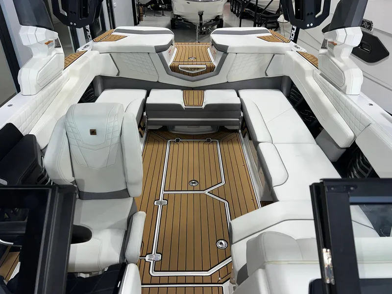 Slide: The Image of 2023 Nautique Super Air G23 boat interior with white seating and teak flooring. - 19