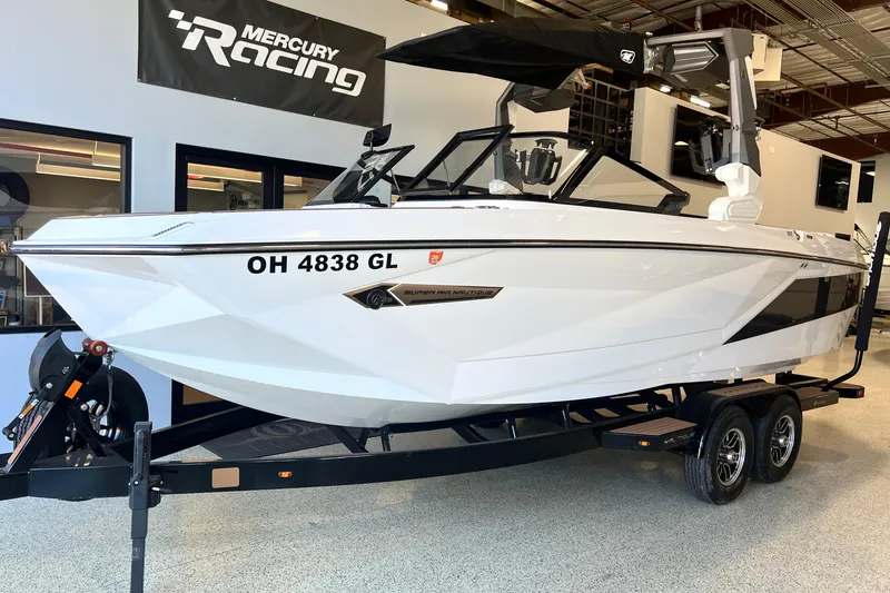Slide: The Image of 2023 Nautique Super Air G23 boat on trailer in showroom. - 2
