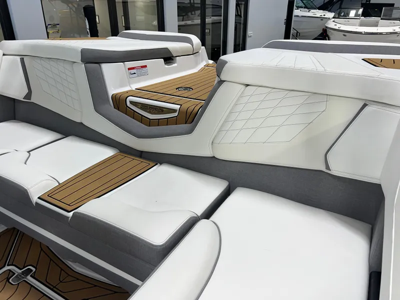 Slide: The Image of 2023 Nautique Super Air G23 interior with white and gray seating, teak accents. - 23