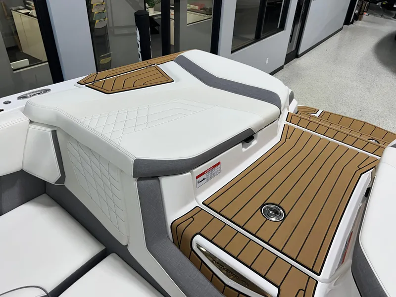 Slide: The Image of 2023 Nautique Super Air G23 boat interior with sleek seating and teak-style flooring. - 24