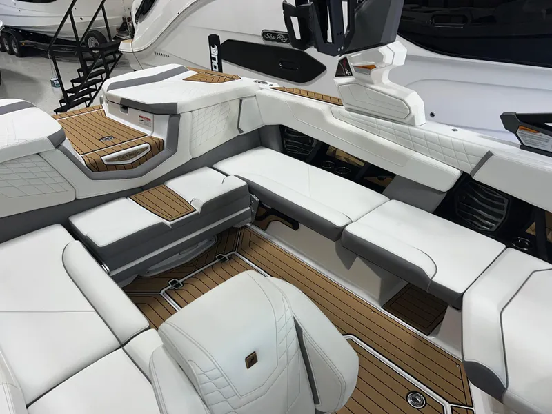 Slide: The Image of 2023 Nautique Super Air G23 interior with white seating and teak flooring. - 25