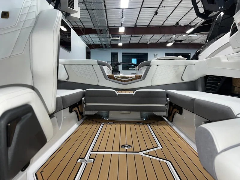 Slide: The Image of 2023 Nautique Super Air G23 interior with luxurious seating and teak flooring. - 27