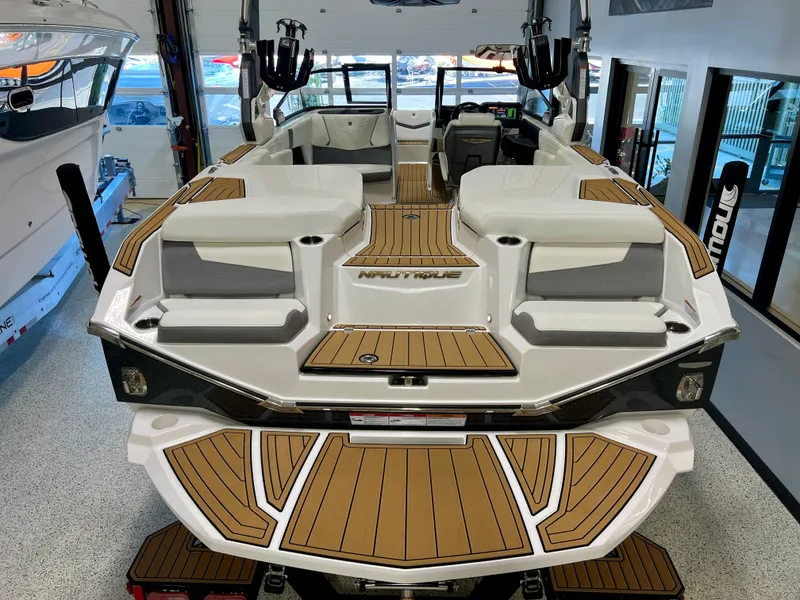 Slide: The Image of 2023 Nautique Super Air G23 boat interior with teak flooring and spacious seating. - 30