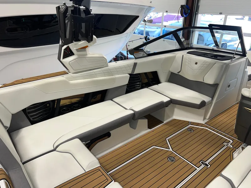 Slide: The Image of 2023 Nautique Super Air G23 boat interior with luxurious seating and teak flooring. - 33