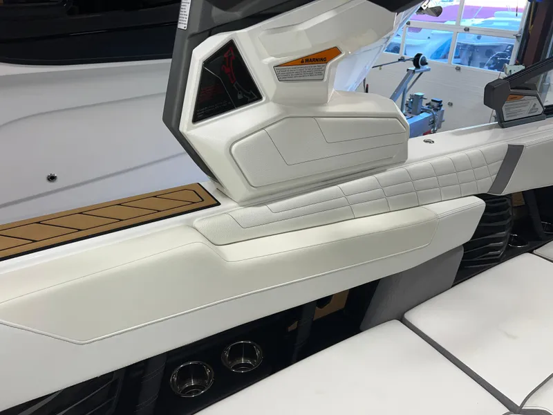 Slide: The Image of 2023 Nautique Super Air G23 interior with white upholstery and modern dashboard design. - 34