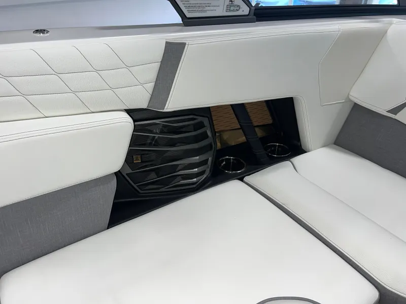 Slide: The Image of 2023 Nautique Super Air G23 interior with white and gray seating and speaker system. - 35
