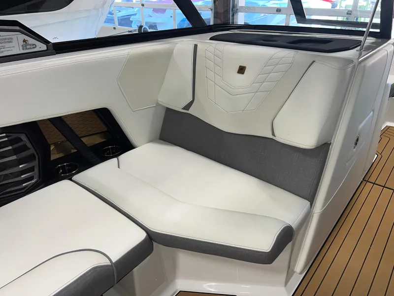 Slide: The Image of 2023 Nautique Super Air G23 interior seating with white and gray upholstery. - 36