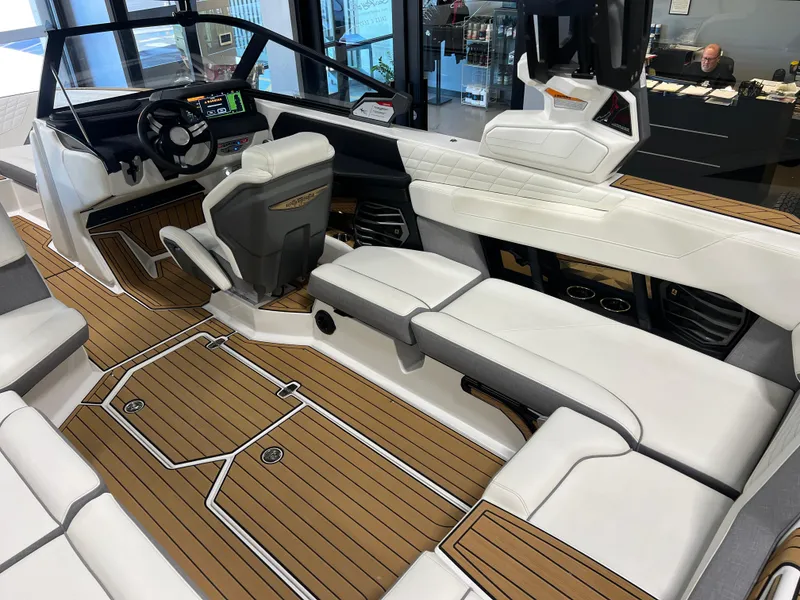 Slide: The Image of 2023 Nautique Super Air G23 boat interior with luxurious seating and modern dashboard. - 37