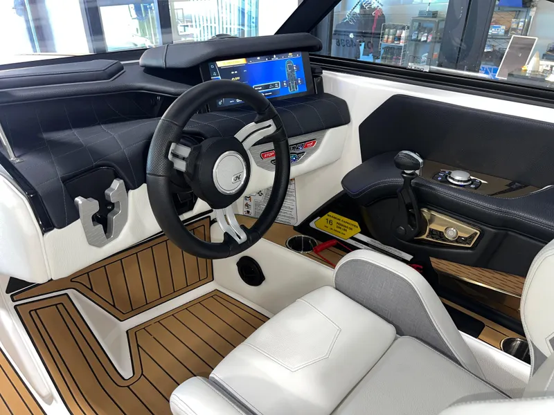 Slide: The Image of 2023 Nautique Super Air G23 boat interior with modern dashboard and steering wheel. - 39