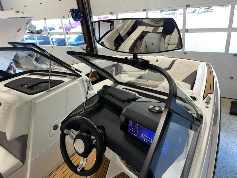 Slide: The Image of 2023 Nautique Super Air G23 boat interior with modern dashboard and steering wheel. - 43