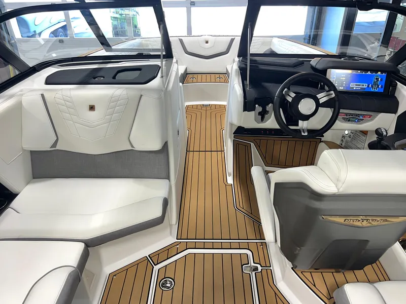 Slide: The Image of 2023 Nautique Super Air G23 boat interior with luxurious seating and modern dashboard. - 44