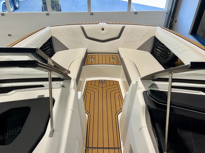 Slide: The Image of 2023 Nautique Super Air G23 boat interior with luxurious seating and teak flooring. - 45