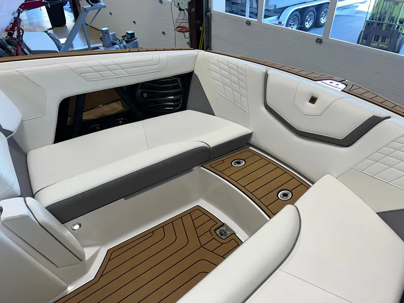 Slide: The Image of 2023 Nautique Super Air G23 boat interior with white seating and teak flooring. - 46