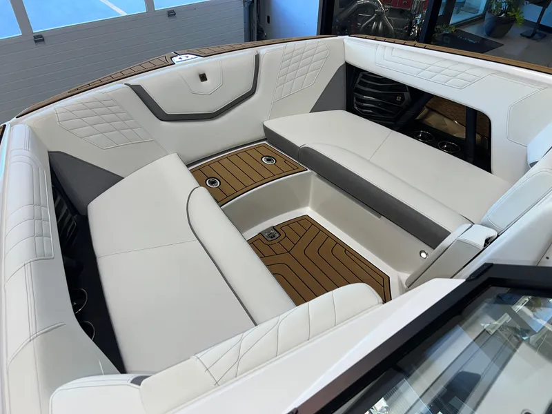 Slide: The Image of Luxurious interior of 2023 Nautique Super Air G23 boat with white seating and wood accents. - 47