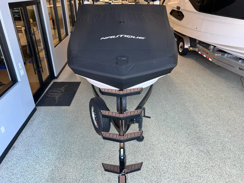 Slide: The Image of 2023 Nautique Super Air G23 boat with cover on trailer in showroom. - 50