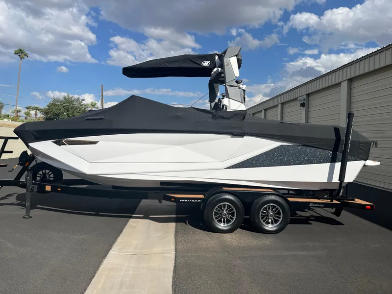 Slide: The Image of 2023 Nautique Super Air G23 boat on trailer, covered, parked outdoors. - 52