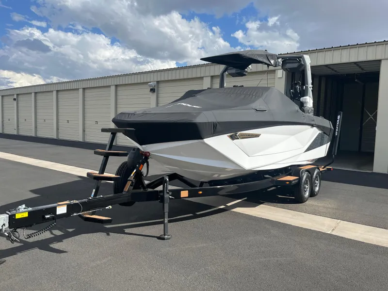 Slide: The Image of 2023 Nautique Super Air G23 boat on trailer, covered, parked outdoors. - 53