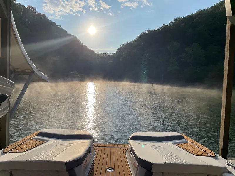 Slide: The Image of 2023 Nautique Super Air G23 on serene lake at sunrise. - 55