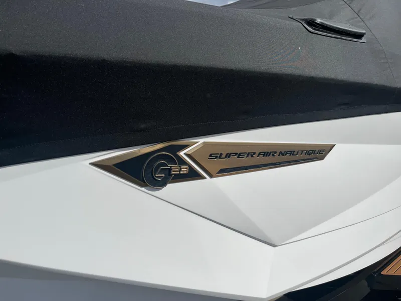 Slide: The Image of 2023 Nautique Super Air G23 boat logo on sleek white hull. - 56