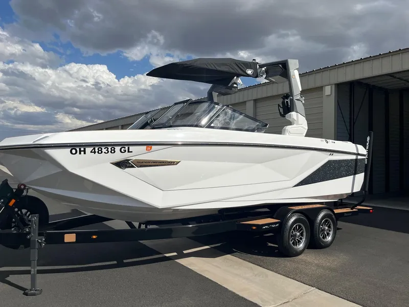 Slide: The Image of 2023 Nautique Super Air G23 boat on trailer, parked outdoors. - 59