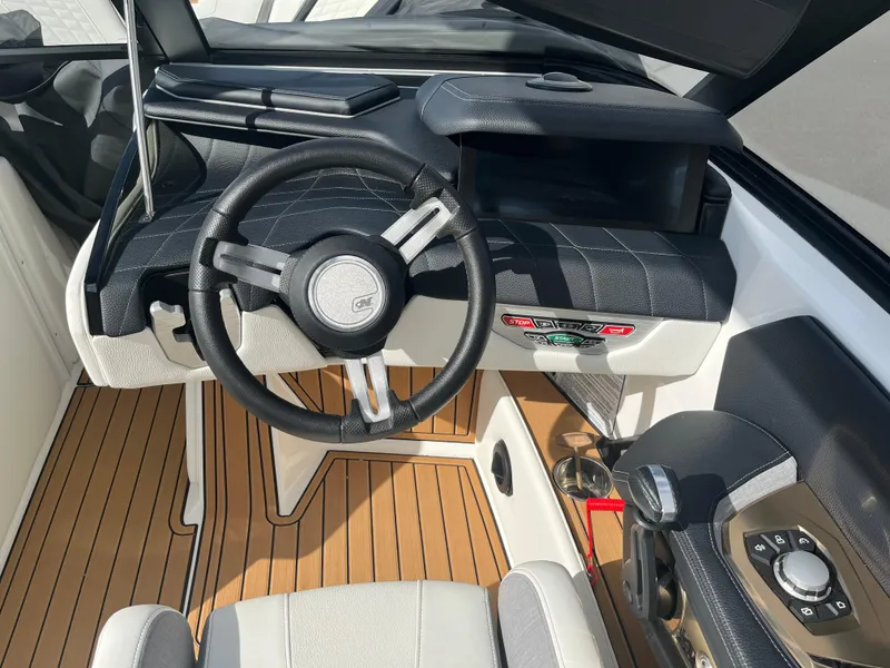 Slide: The Image of 2023 Nautique Super Air G23 boat interior with steering wheel and dashboard. - 65