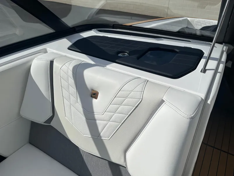 Slide: The Image of 2023 Nautique Super Air G23 interior with sleek white upholstery and modern design. - 66