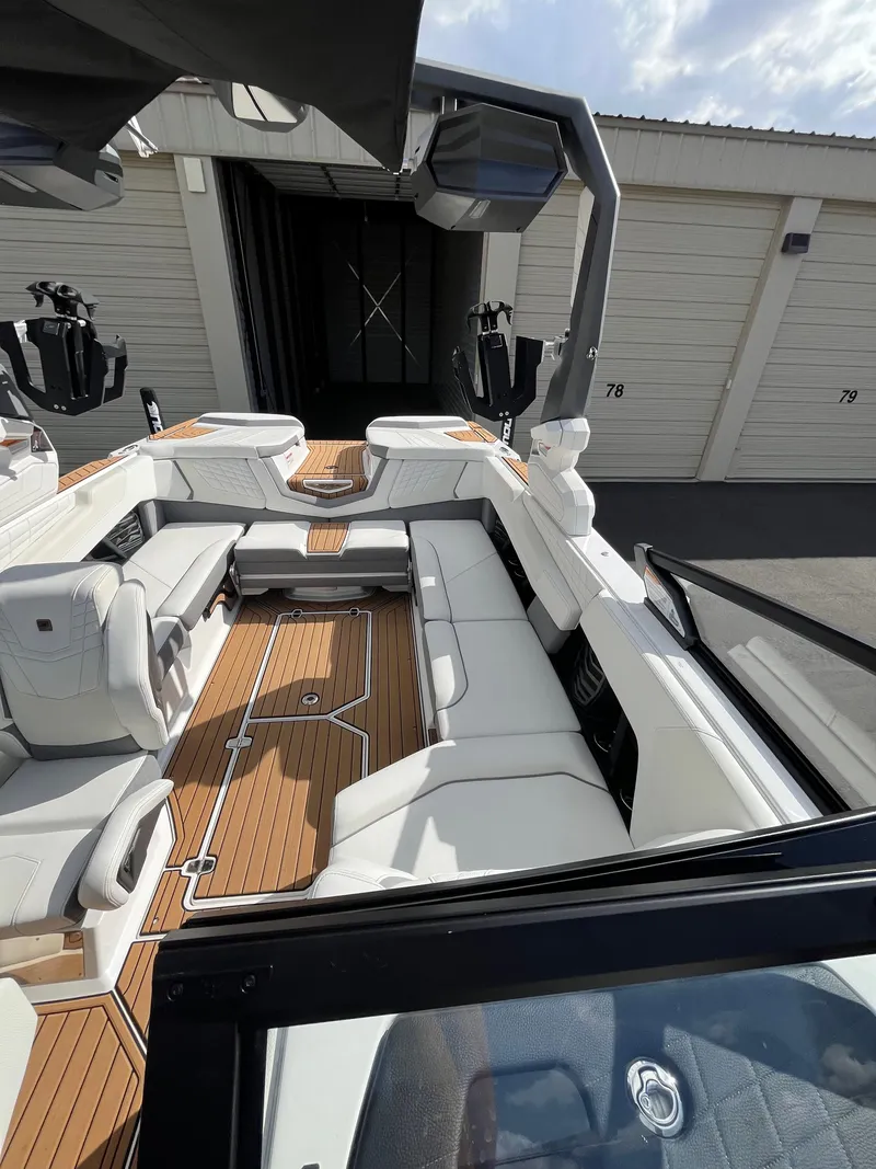 Slide: The Image of 2023 Nautique Super Air G23 boat with luxurious white seating and teak flooring. - 67