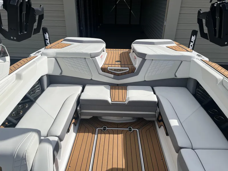 Slide: The Image of 2023 Nautique Super Air G23 interior with luxurious seating and teak flooring. - 69