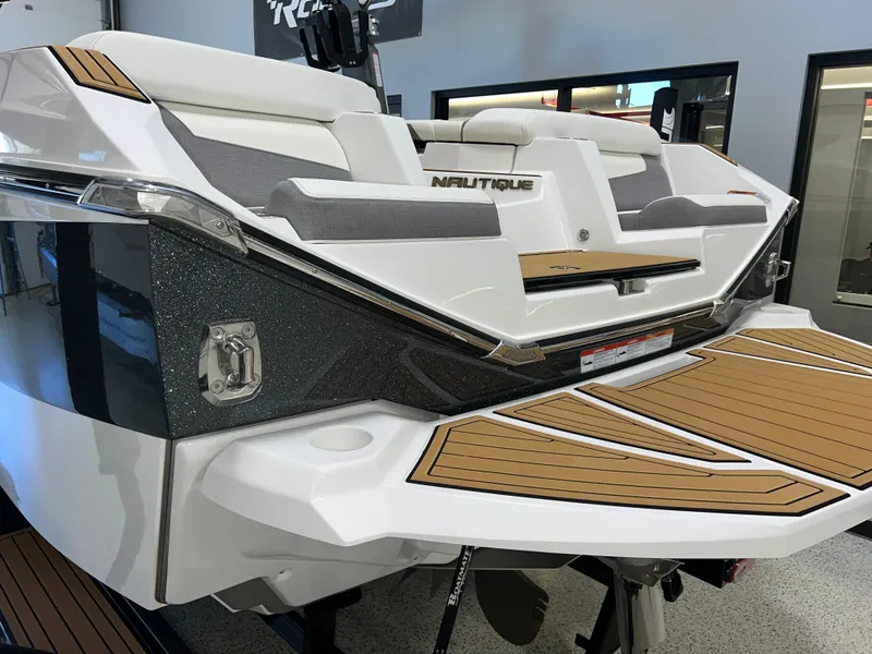 Slide: The Image of 2023 Nautique Super Air G23 boat with sleek design and teak deck. - 7