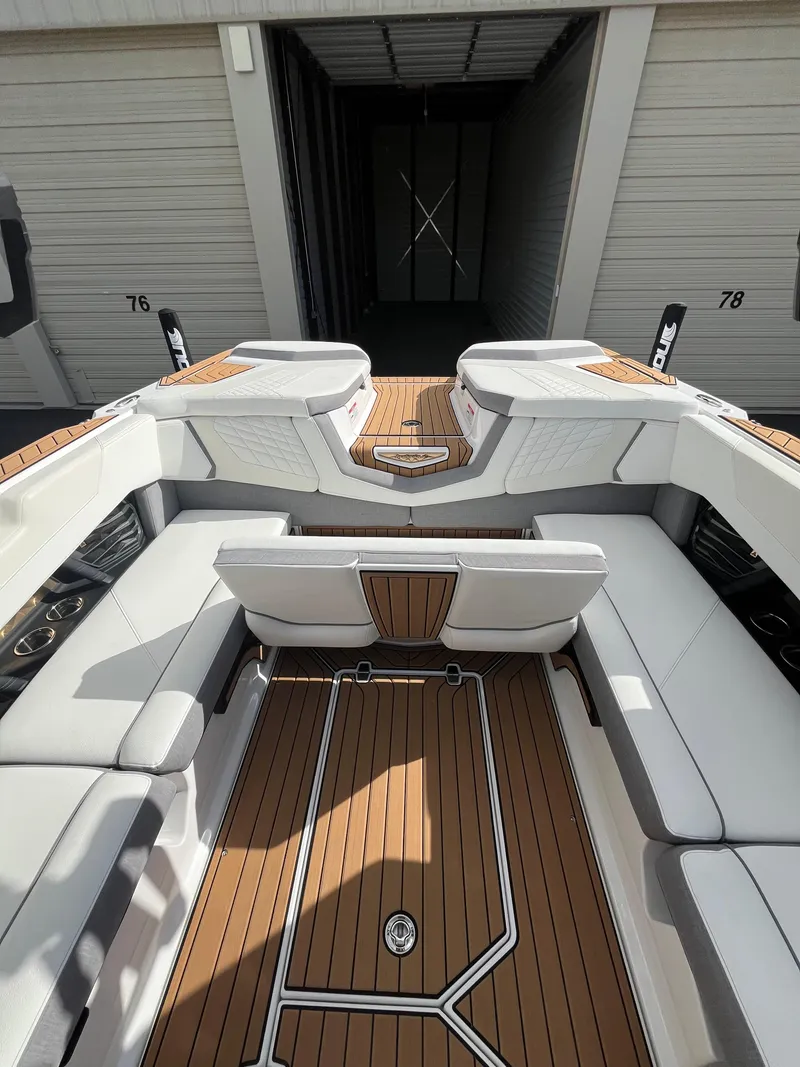 Slide: The Image of 2023 Nautique Super Air G23 boat interior with sleek seating and wood finish. - 71