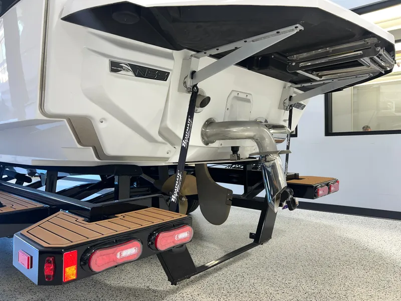 Slide: The Image of 2023 Nautique Super Air G23 boat rear view with trailer and exhaust system. - 8