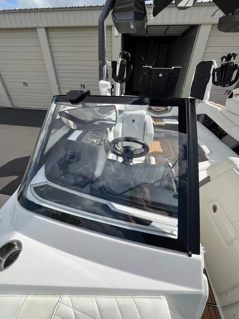 Slide: The Image of 2023 Nautique Super Air G23 boat interior with steering wheel and dashboard. - 82