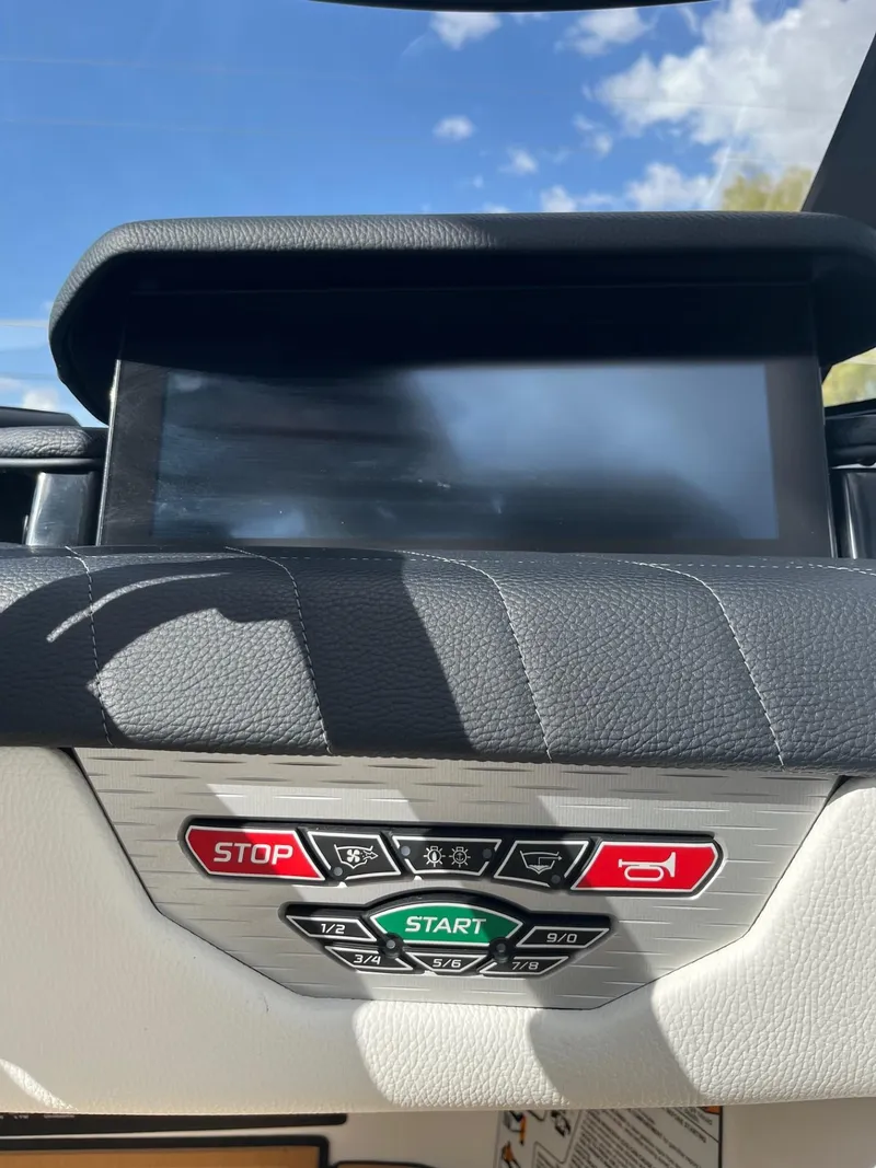 Slide: The Image of 2023 Nautique Super Air G23 dashboard with control buttons and display screen. - 91